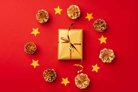 Red Christmas composition with gold cones and decorations