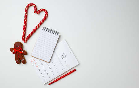 Christmas card and candy canes on white backgroundの写真素材