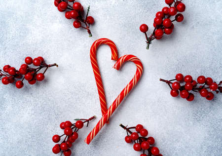 Candy canes on grey frosted background top viewの写真素材