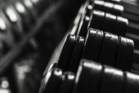 Sports equipment in gym. Dumbbells of different weight close upの写真素材