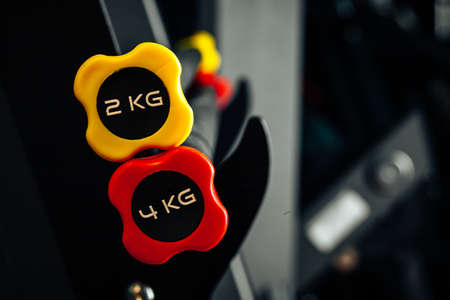 Sports equipment in gym. Dumbbells of different weight close upの写真素材