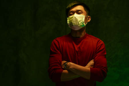 Portrait of a Chinese man wearing medical protective mask. Coronavirus protection conceptの写真素材