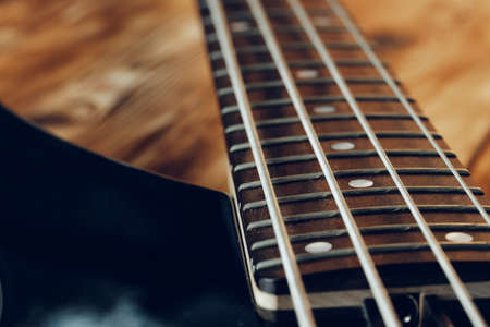 Close up photo of electric guitar fingerboard