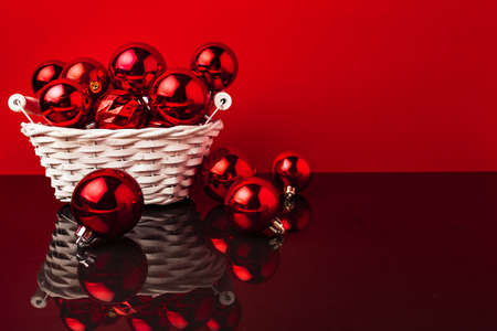 Pile of red Christmas baubles in a basket