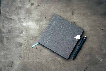 Mens diary and pen on dark grey backgroundの写真素材