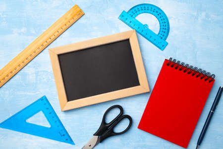Mini blackboard in wooden frame and school supplies