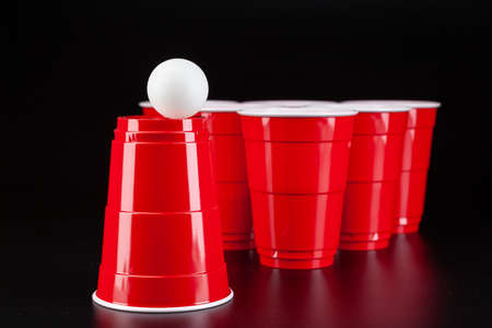 Red plastic cups and ball for game of beer pongの写真素材