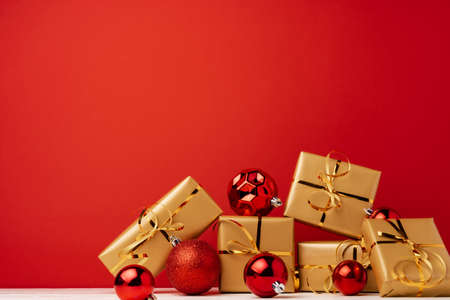 Christmas gift boxes against red background front viewの写真素材