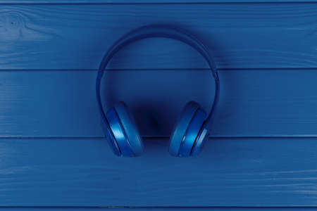 Blue headphones on blue background, top viewの写真素材