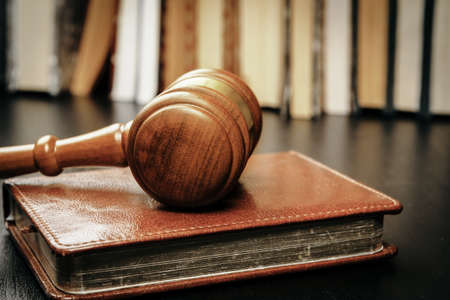 Image of wooden judge hammer on notepadの写真素材