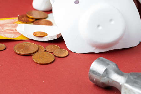 Broken piggy bank with ukrainian money notes and coins. Decline in living standards concept