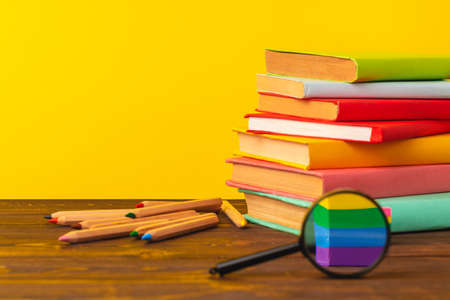 Stacked books on wooden desk front viewの写真素材