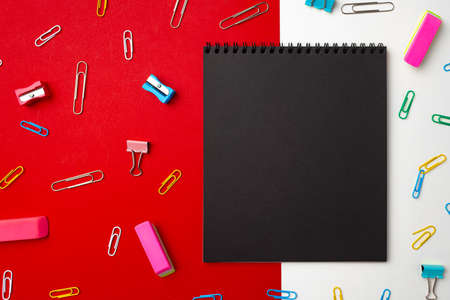 Black notepad surrounded with paper clips top viewの写真素材