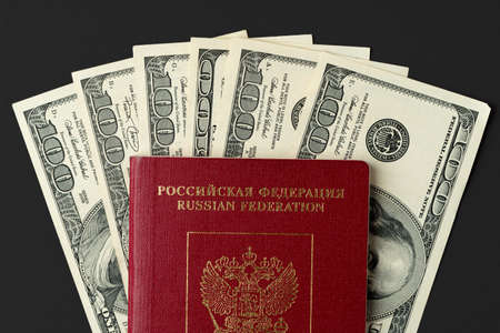 Russian passport with US dollar banknotes insideの写真素材