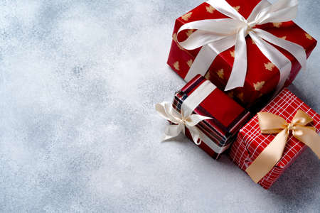 Red Christmas gift box on grey frosted background