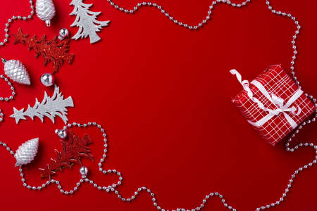 Red background with carved wooden Christmas treesの写真素材