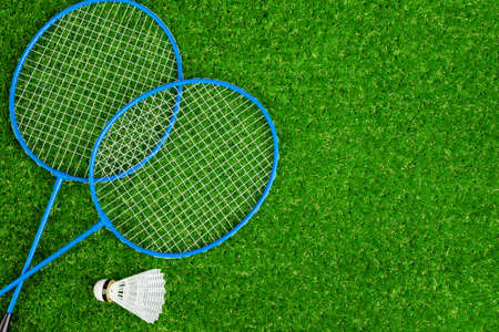 Badminton game rackets and shuttlecock on grassの写真素材