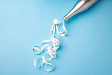 Champagne bottle with streamers flat lay top viewの写真素材