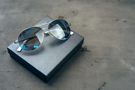 New dark aviator glasses on grey concrete backgroundの写真素材