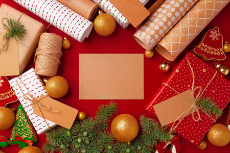 Christmas preparations concept with wrapping paper, gift boxes on red backgroundの写真素材