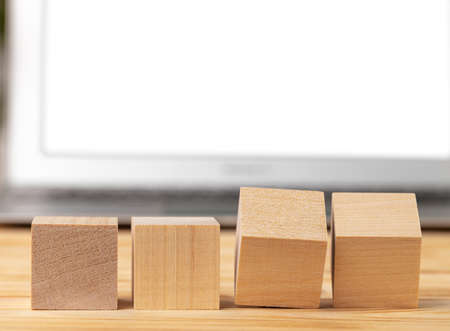 Blank wooden cubes with copy space for your design on office working table