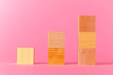 Toy wooden cubes with copy space against pink backgroundの写真素材