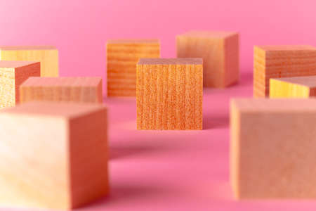 Toy wooden cubes with copy space against pink backgroundの写真素材