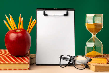 Blank clipboard with copy space and school supplies
