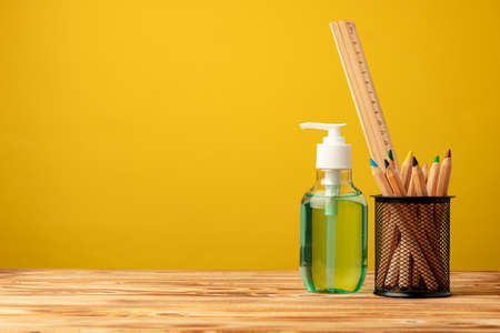 School stationery and hand sanitizer. Back to school concept while coronavirus pandemicの写真素材