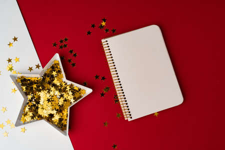 Star shaped plate with golden confetti top viewの写真素材