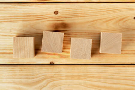 Groupped wooden square blocks on dark wooden tableの写真素材