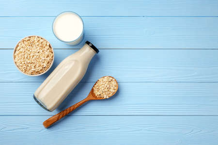 Non dairy oat milk and oat flakes in bowlの写真素材