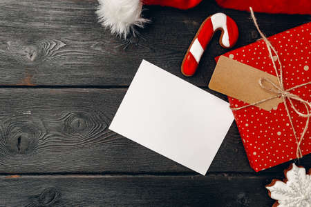 Santa Claus cap and Christmas gift on wooden background top viewの写真素材