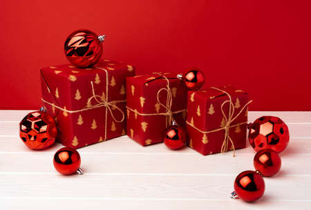 Christmas gift boxes against red background front viewの写真素材