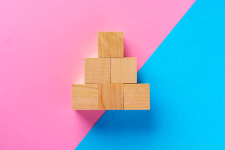Top view photo of wooden blocks on pink and blueの写真素材