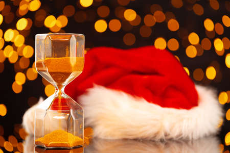 Golden hourglass against bokeh lights, Christmas backgroundの写真素材