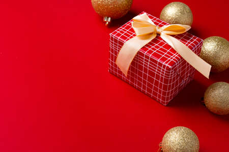 Christmas baubles and wrapped gift decorated with bowの写真素材