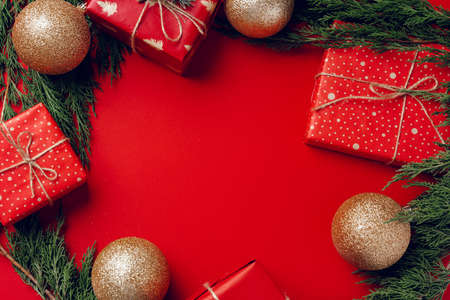 Red festive Christmas background with coniferous branchesの写真素材