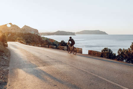 Cyclist riding on his bicycle at coastal road