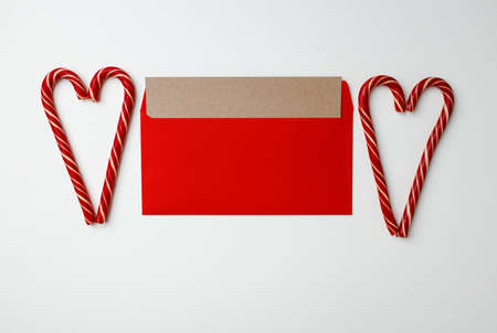 Christmas card and candy canes on white background