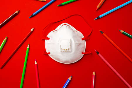 Colorful pencils and medical face mask. Pandemic education conceptの写真素材