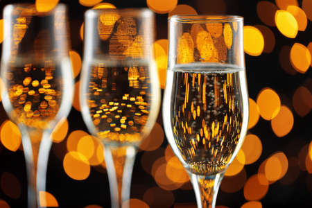 Close up photo of Champagne glasses against bokeh backgroundの写真素材