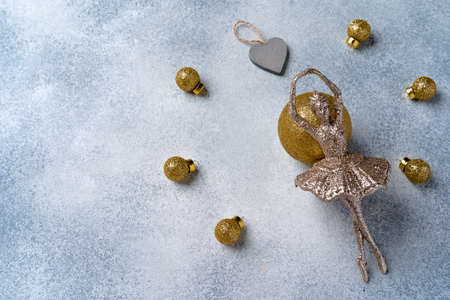 Grey and gold Christmas baubles on frosted background