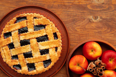 Homemade traditional sweet autumn tart pie on wooden tableの写真素材