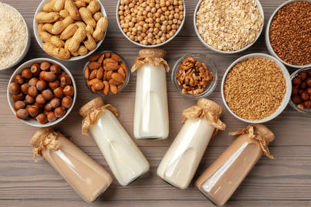 Concept of organic vegan non dairy milk with glass milk bottle and bulk products