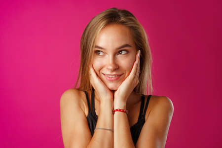 Studio portrait of beautiful young casual woman thinking