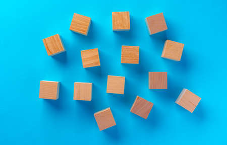 Top view of wooden toy blocks on blue