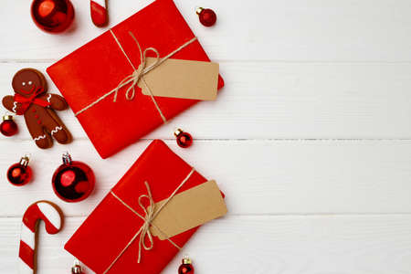 Christmas present and festive gingerbread cookies on wooden background