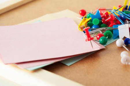Sticky notes with pushpins and blank space on cork background. School or business conceptの写真素材