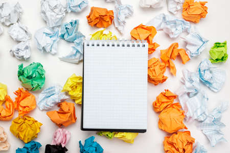 Office workspace with an empty notebook, crumpled paperの写真素材